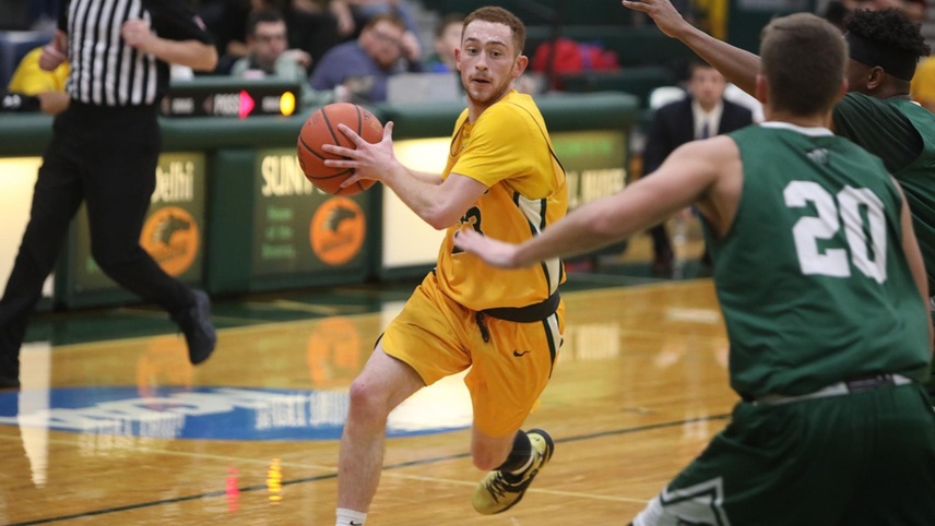 Jordan Fragale driving the ball in against a pair of defenders.