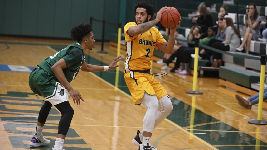 Justin Daoud with a defender on him looking to pass the ball.