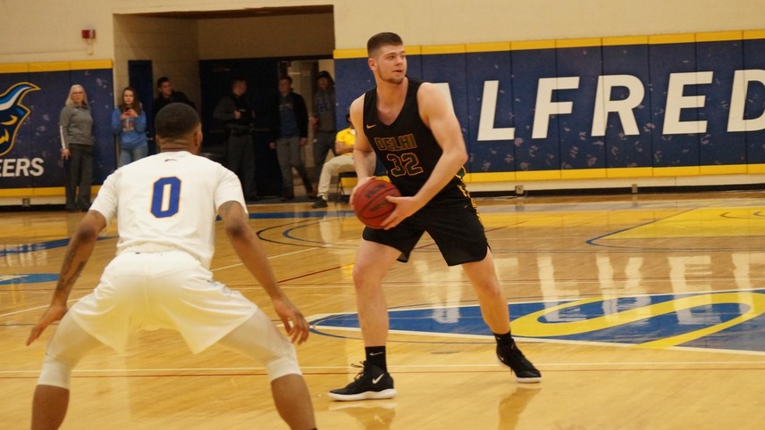 #32 Payton Dean at the top of the key looking to pass the ball.