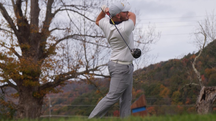 golfer teeing off