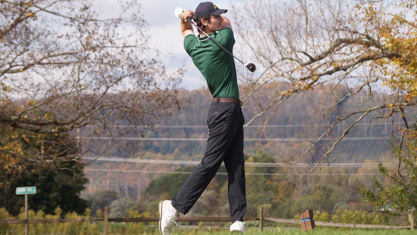 golfer teeing off