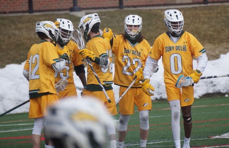 #55 Malik Talbert being congratulated by teammates after scoring a goal. 