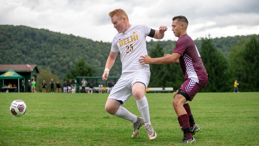 Brody Rettle fielding the ball with an opponent behind him. 