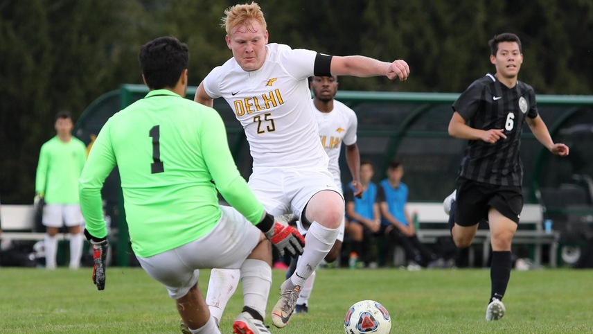 Brody Rettle trying to move the ball past the charging goalkeeper.