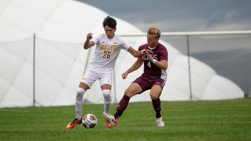 Juan Velez fields a ball with a defender on him.