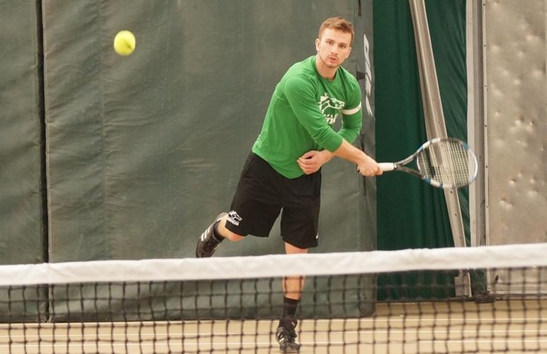 Michael Zerniak delivering a serve.