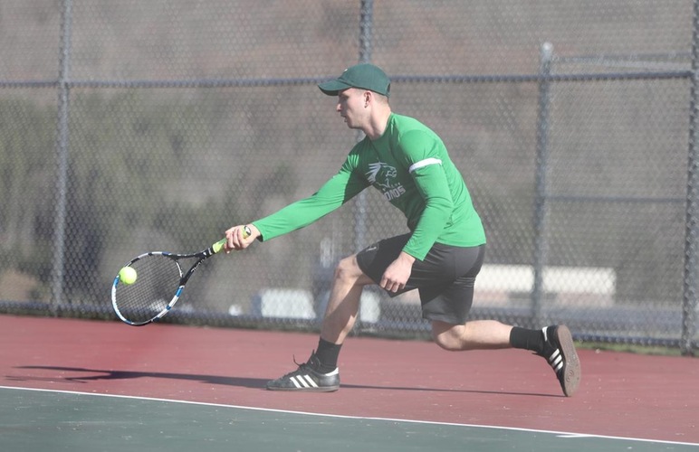Mike Zerniak stretching to return a shot versus Utica. 