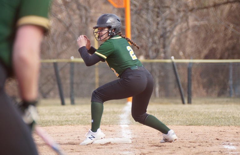 Mackenzie Sparacino on first base receiving baserunning signals. 