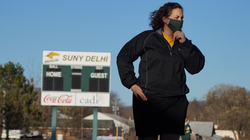 person in front of scoreboard