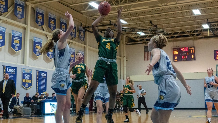 Camryn McDonald putting up a shot in front of two defenders. 