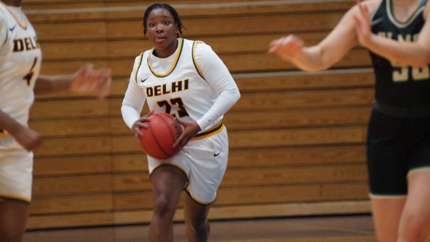 Samiaya Salley looking upcourt with the ball looking to pass to a teammate.