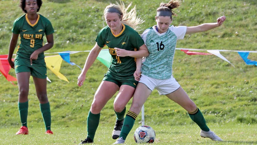 Alexa DuBois challenging for the ball against an opponent.