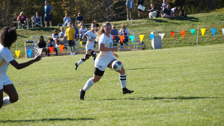 Olivia Curry fielding the ball on the run.