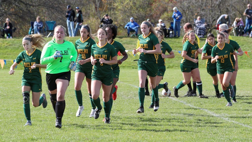 The team runs towards the sidelines for final preparations prior to a game.