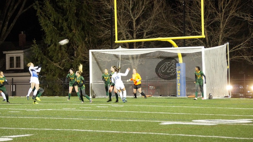 The women's soccer team gets ready to defend the ball of a corner kick