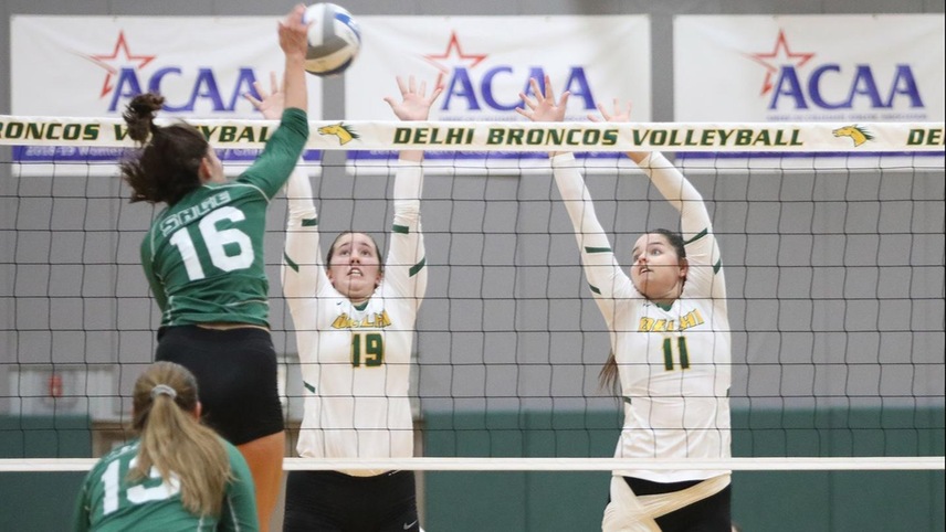 Erica Prindle and Haylee Lefebvre attempt to block an attack.